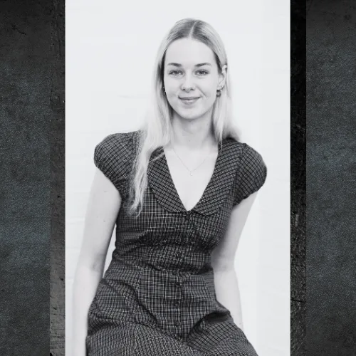 Hannah Holgate of AdaptAd seated in a patterned dress, black and white portrait
